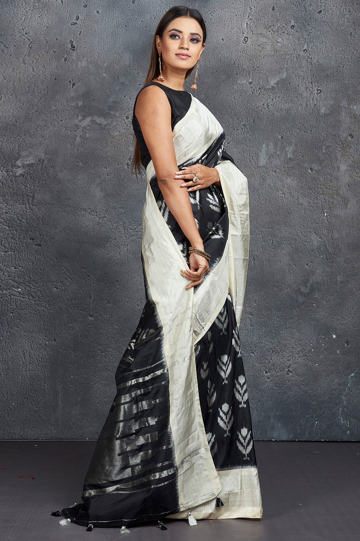 Shop stunning black ikkat silk saree online in USA with cream zari border. Keep your ethnic wardrobe up to date with latest designer sarees, pure silk sarees, Kanchipuram silk sarees, handwoven sarees, tussar silk sarees, embroidered sarees from Pure Elegance Indian saree store in USA.-side