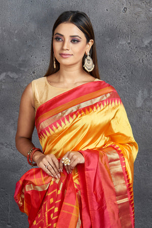 Shop beautiful yellow pure silk saree online in USA with ikkat pallu. Keep your ethnic wardrobe up to date with latest designer sarees, pure silk sarees, Kanchipuram silk sarees, handwoven sarees, tussar silk sarees, embroidered sarees from Pure Elegance Indian saree store in USA.-closeup