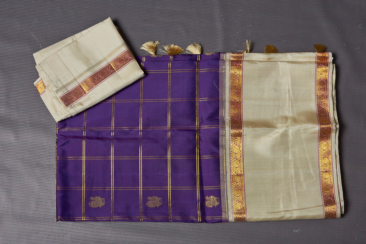Buy stunning purple check Kanjivaram saree online in USA with cream space border. Keep your ethnic wardrobe up to date with latest designer sarees, pure silk sarees, Kanchipuram silk sarees, handwoven sarees, tussar silk sarees, embroidered sarees from Pure Elegance Indian saree store in USA.-blouse