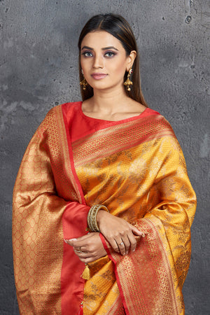 Shop stunning mustard golden tussar Banarasi sari online in USA with golden border. Keep your ethnic wardrobe up to date with latest designer sarees, pure silk sarees, Kanchipuram silk sarees, handwoven sarees, tussar silk sarees, embroidered sarees from Pure Elegance Indian saree store in USA.-closeup