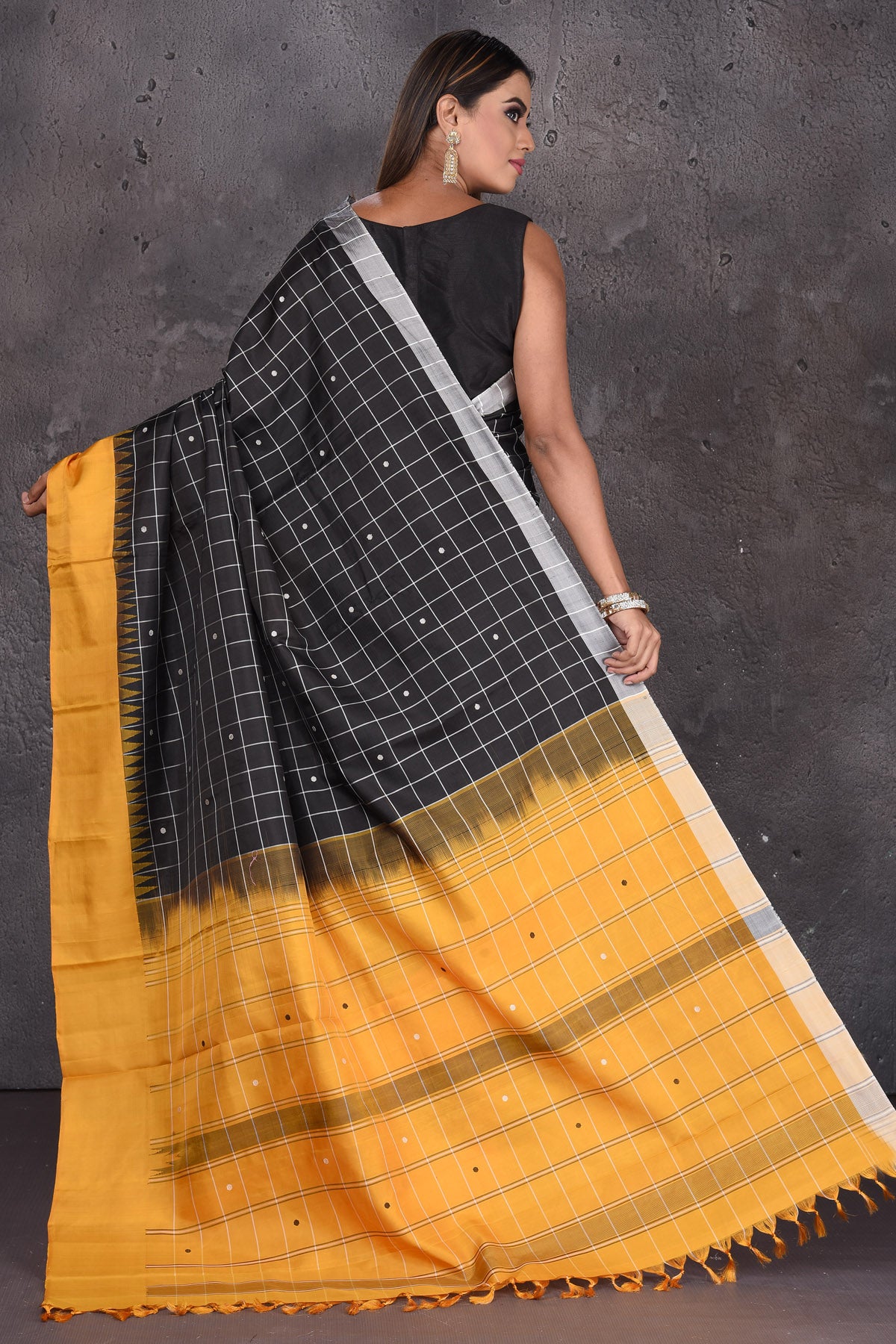 Buy beautiful black zari check Kanjeevaram silk saree online in USA with mustard border. Keep your ethnic wardrobe up to date with latest designer sarees, pure silk sarees, handwoven sarees, tussar silk sarees, embroidered sarees from Pure Elegance Indian saree store in USA.-back