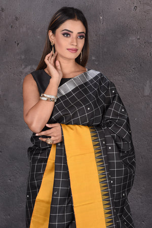 Buy beautiful black zari check Kanjeevaram silk saree online in USA with mustard border. Keep your ethnic wardrobe up to date with latest designer sarees, pure silk sarees, handwoven sarees, tussar silk sarees, embroidered sarees from Pure Elegance Indian saree store in USA.-closeup