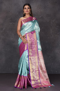Buy stunning light blue Kanjeevaram sari online in USA with purple zari border. Keep your ethnic wardrobe up to date with latest designer sarees, pure silk sarees, handwoven sarees, tussar silk sarees, embroidered sarees, printed sarees from Pure Elegance Indian saree store in USA.-full view