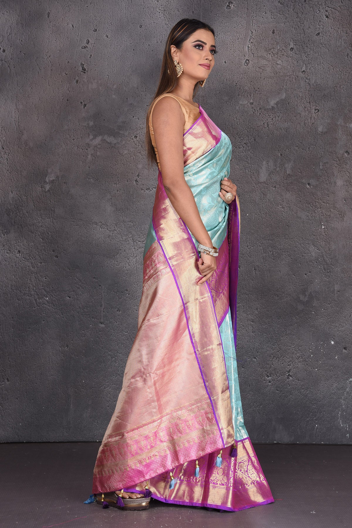 Buy stunning light blue Kanjeevaram sari online in USA with purple zari border. Keep your ethnic wardrobe up to date with latest designer sarees, pure silk sarees, handwoven sarees, tussar silk sarees, embroidered sarees, printed sarees from Pure Elegance Indian saree store in USA.-side