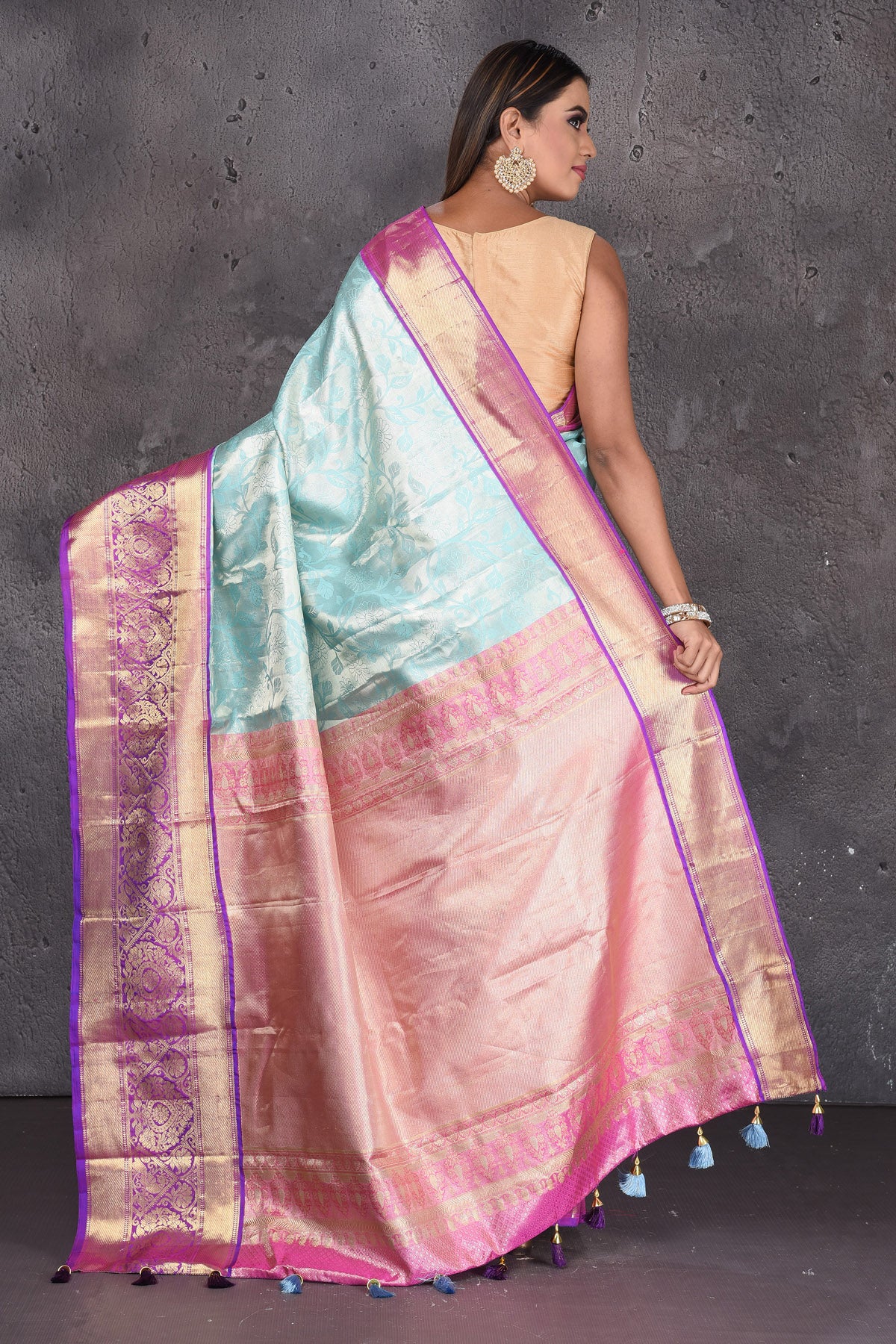 Buy stunning light blue Kanjeevaram sari online in USA with purple zari border. Keep your ethnic wardrobe up to date with latest designer sarees, pure silk sarees, handwoven sarees, tussar silk sarees, embroidered sarees, printed sarees from Pure Elegance Indian saree store in USA.-back