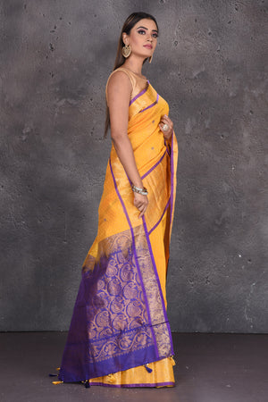 Shop yellow mangalgiri saree online in USA with purple zari pallu. Keep your ethnic wardrobe up to date with latest designer sarees, pure silk sarees, handwoven sarees, tussar silk sarees, embroidered sarees, printed sarees from Pure Elegance Indian saree store in USA.-side