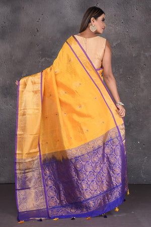 Shop yellow mangalgiri saree online in USA with purple zari pallu. Keep your ethnic wardrobe up to date with latest designer sarees, pure silk sarees, handwoven sarees, tussar silk sarees, embroidered sarees, printed sarees from Pure Elegance Indian saree store in USA.-back