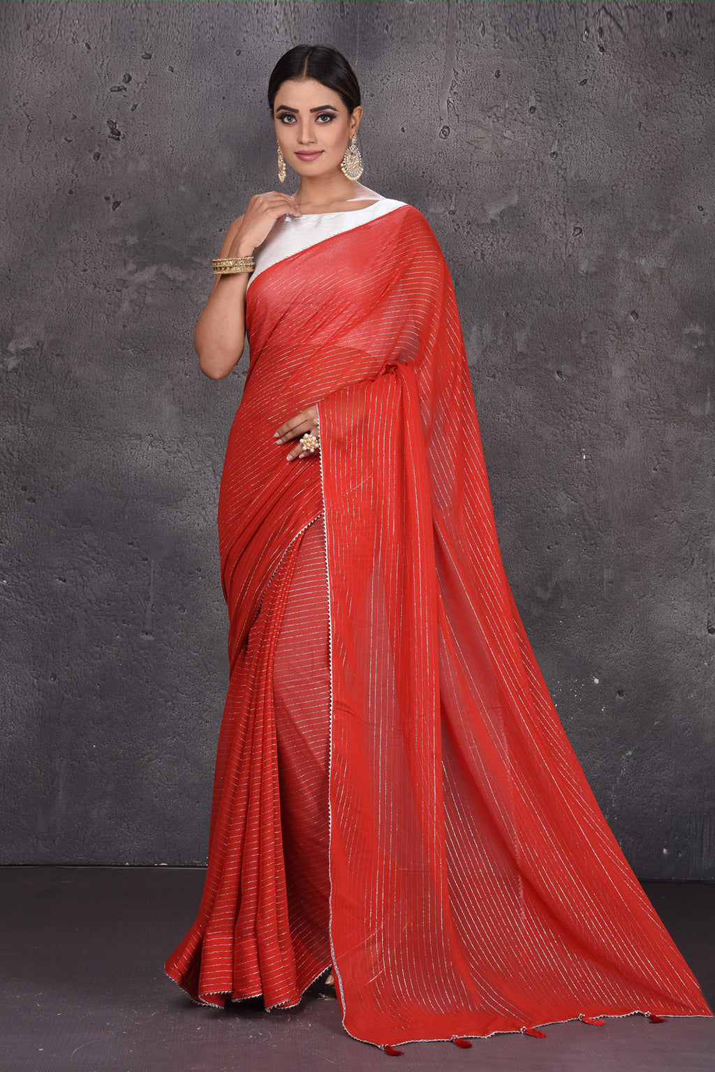 Buy gorgeous red fancy georgette saree online in USA with zari stripes. Keep your ethnic wardrobe up to date with latest designer sarees, pure silk sarees, handwoven sarees, tussar silk sarees, embroidered sarees from Pure Elegance Indian saree store in USA.-full view