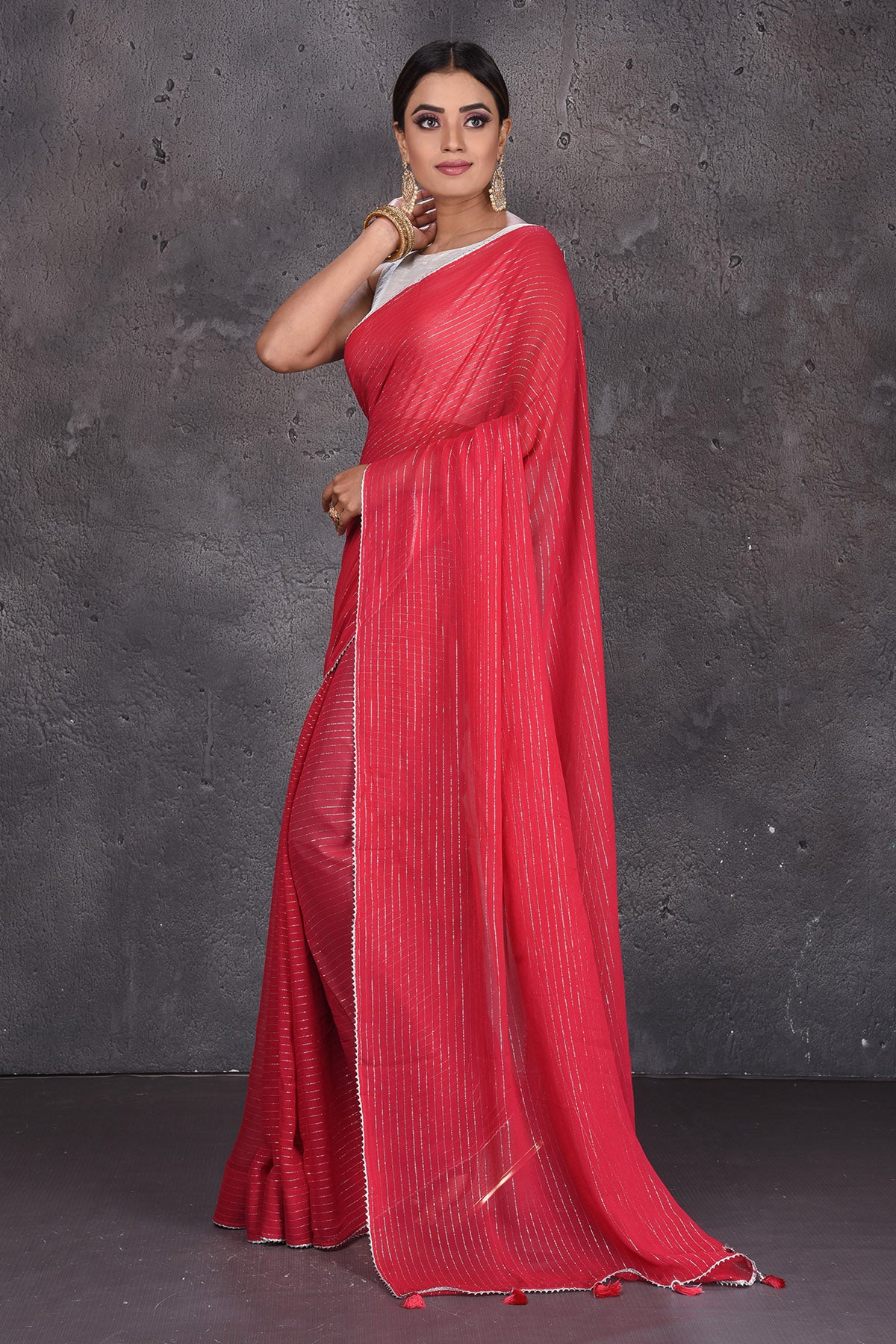 Shop gorgeous red fancy georgette sari online in USA with zari stripes. Keep your ethnic wardrobe up to date with latest designer sarees, pure silk sarees, handwoven sarees, tussar silk sarees, embroidered sarees from Pure Elegance Indian saree store in USA.-side