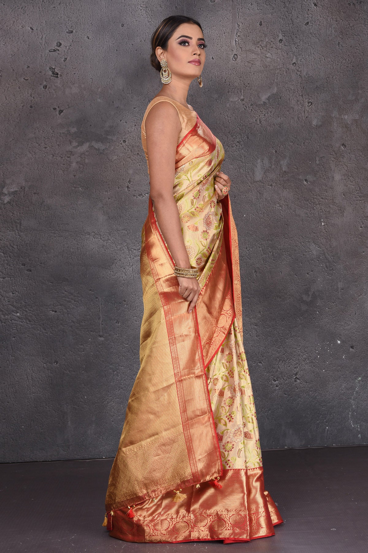Buy stunning creamish gold floral minakari Kanjeevaram saree online in USA with red golden border. Keep your ethnic wardrobe up to date with latest designer sarees, pure silk sarees, handwoven sarees, Kanchipuram silk sarees, embroidered sarees, georgette sarees from Pure Elegance Indian saree store in USA.-side