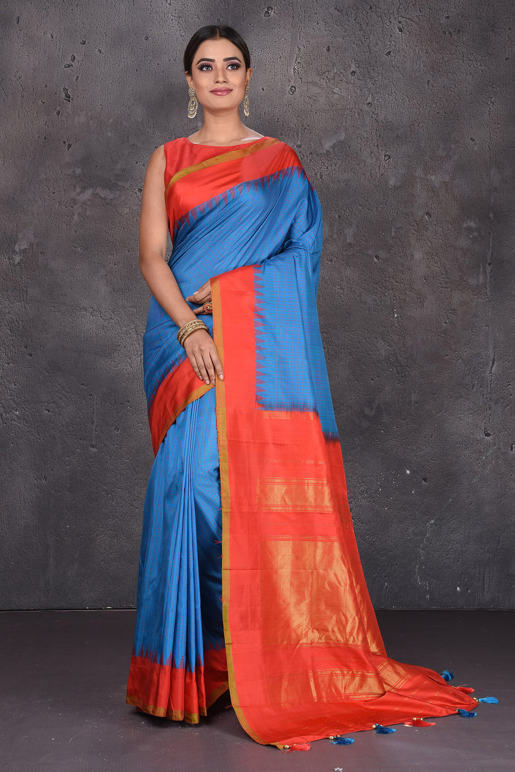 Buy stunning blue Gadhwal handloom silk saree online in USA with red zari border. Keep your ethnic wardrobe up to date with latest designer sarees, pure silk sarees, handwoven sarees, Kanchipuram silk sarees, embroidered sarees, georgette sarees from Pure Elegance Indian saree store in USA.-full view