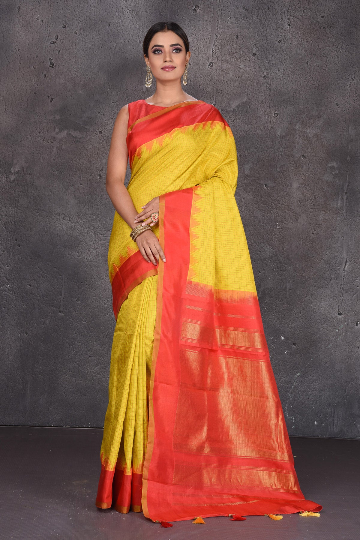 Buy beautiful yellow Gadhwal handloom silk sari online in USA with red zari border. Keep your ethnic wardrobe up to date with latest designer sarees, pure silk sarees, handwoven sarees, Kanchipuram silk sarees, embroidered sarees, georgette sarees from Pure Elegance Indian saree store in USA.-full view