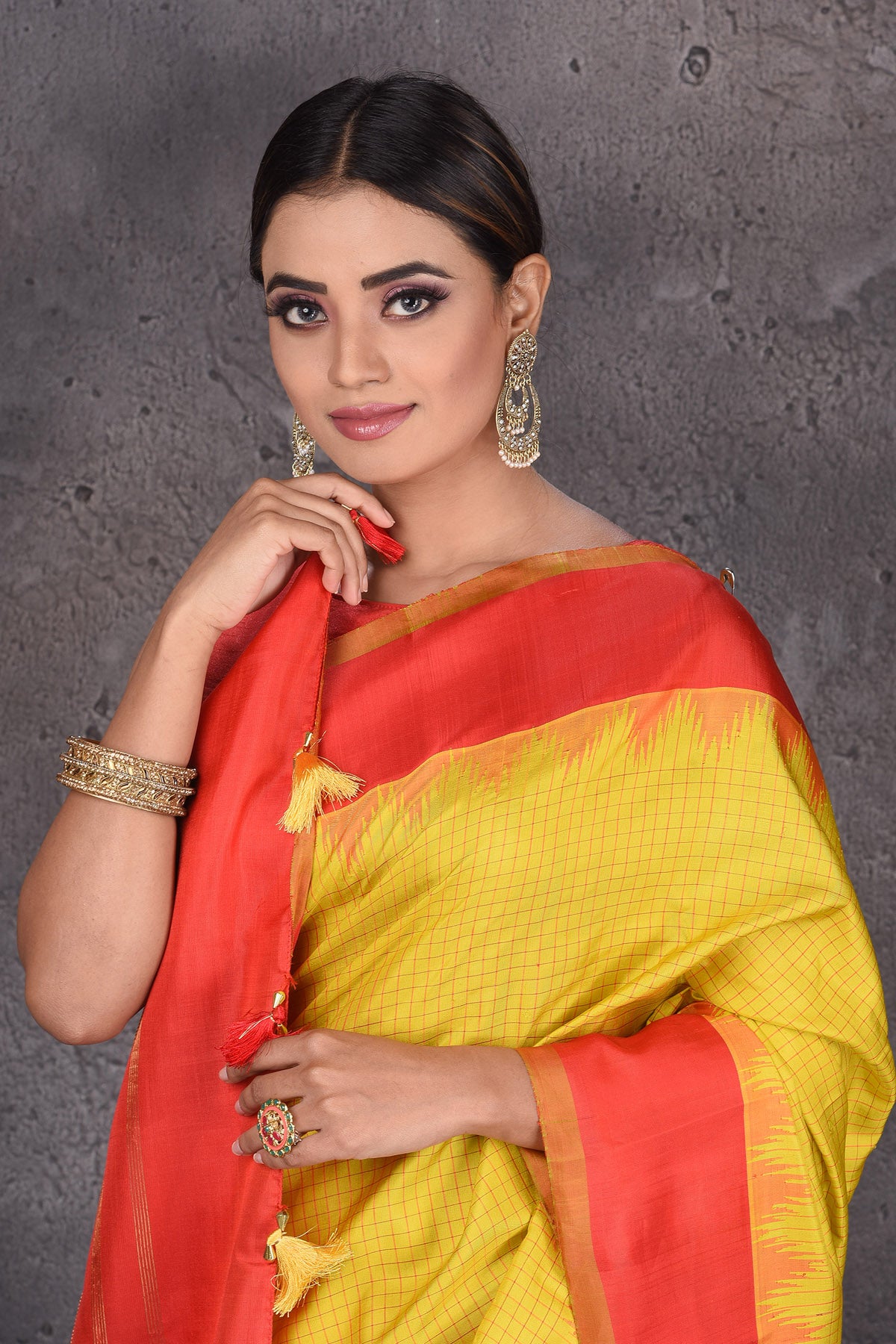 Buy beautiful yellow Gadhwal handloom silk sari online in USA with red zari border. Keep your ethnic wardrobe up to date with latest designer sarees, pure silk sarees, handwoven sarees, Kanchipuram silk sarees, embroidered sarees, georgette sarees from Pure Elegance Indian saree store in USA.-closeup