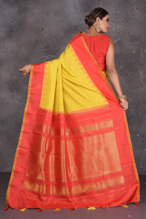Buy beautiful yellow Gadhwal handloom silk sari online in USA with red zari border. Keep your ethnic wardrobe up to date with latest designer sarees, pure silk sarees, handwoven sarees, Kanchipuram silk sarees, embroidered sarees, georgette sarees from Pure Elegance Indian saree store in USA.-back