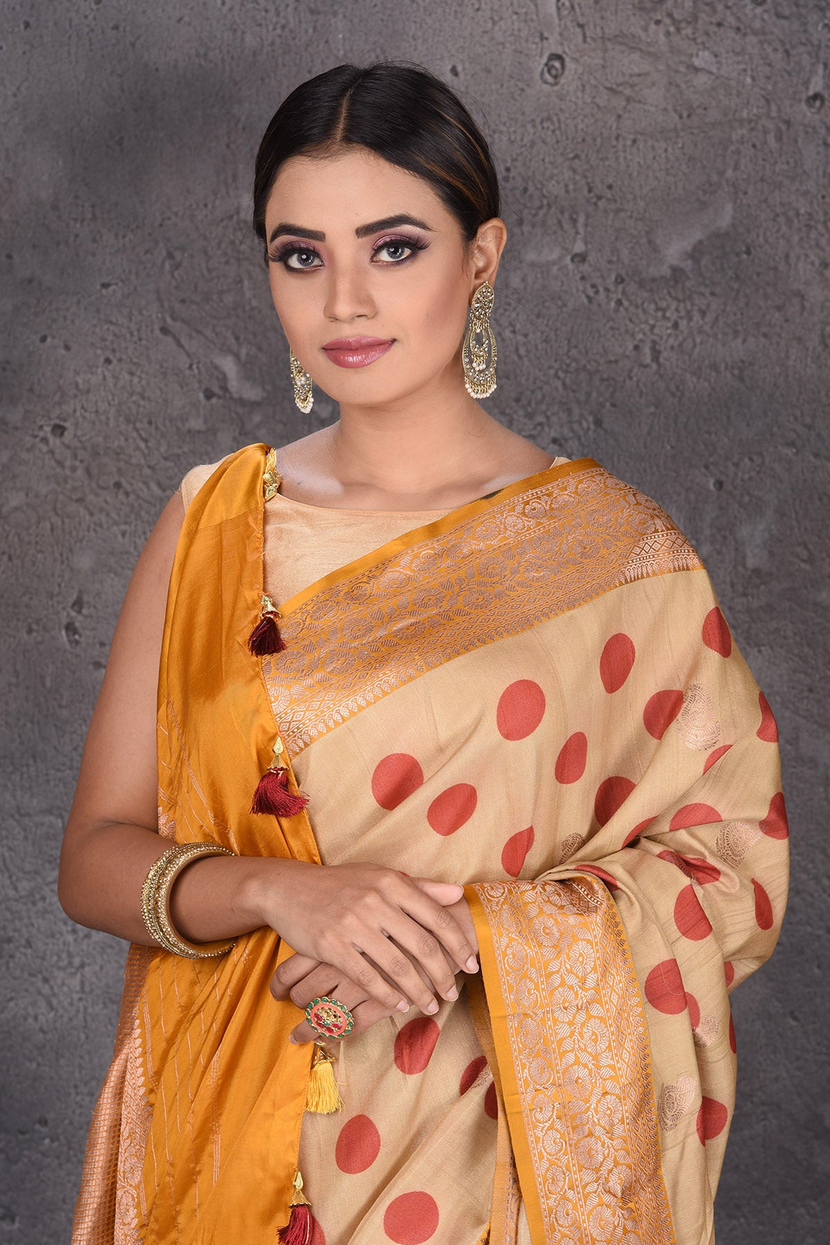 Buy beautiful beige polka dot tussar handloom saree online in USA with zari border. Keep your ethnic wardrobe up to date with latest designer sarees, pure silk sarees, handwoven sarees, Kanchipuram silk sarees, embroidered sarees, georgette sarees from Pure Elegance Indian saree store in USA.-closeup
