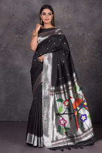 Shop black Paithani silk saree online in USA with single muniya zari border. Keep your ethnic wardrobe up to date with latest designer sarees, pure silk sarees, handwoven sarees, tussar silk sarees, embroidered saris, Paithani sarees from Pure Elegance Indian saree store in USA.-full view