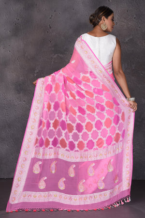 Buy beautiful neon pink Banarasi silk saree online in USA with silver zari border. Keep your ethnic wardrobe up to date with latest designer saris, pure silk sarees, handwoven silk sarees, tussar silk sarees, Benarasi sarees, embroidered sarees from Pure Elegance Indian saree store in USA.-back