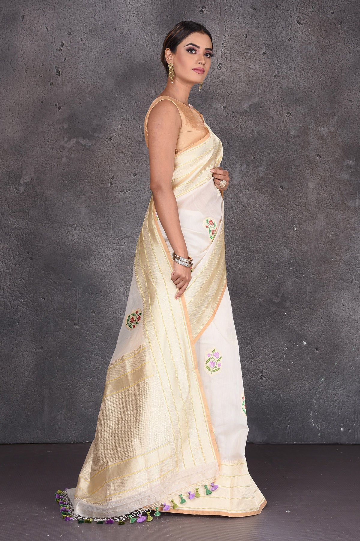 Buy stunning cream linen silk Banarasi saree online in USA with floral buta and zari border. Keep your ethnic wardrobe up to date with latest designer saris, pure silk sarees, handwoven silk sarees, tussar silk sarees, Benarasi sarees, embroidered sarees from Pure Elegance Indian saree store in USA.-side