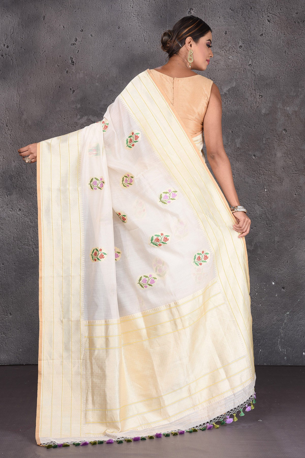 Buy stunning cream linen silk Banarasi saree online in USA with floral buta and zari border. Keep your ethnic wardrobe up to date with latest designer saris, pure silk sarees, handwoven silk sarees, tussar silk sarees, Benarasi sarees, embroidered sarees from Pure Elegance Indian saree store in USA.-back