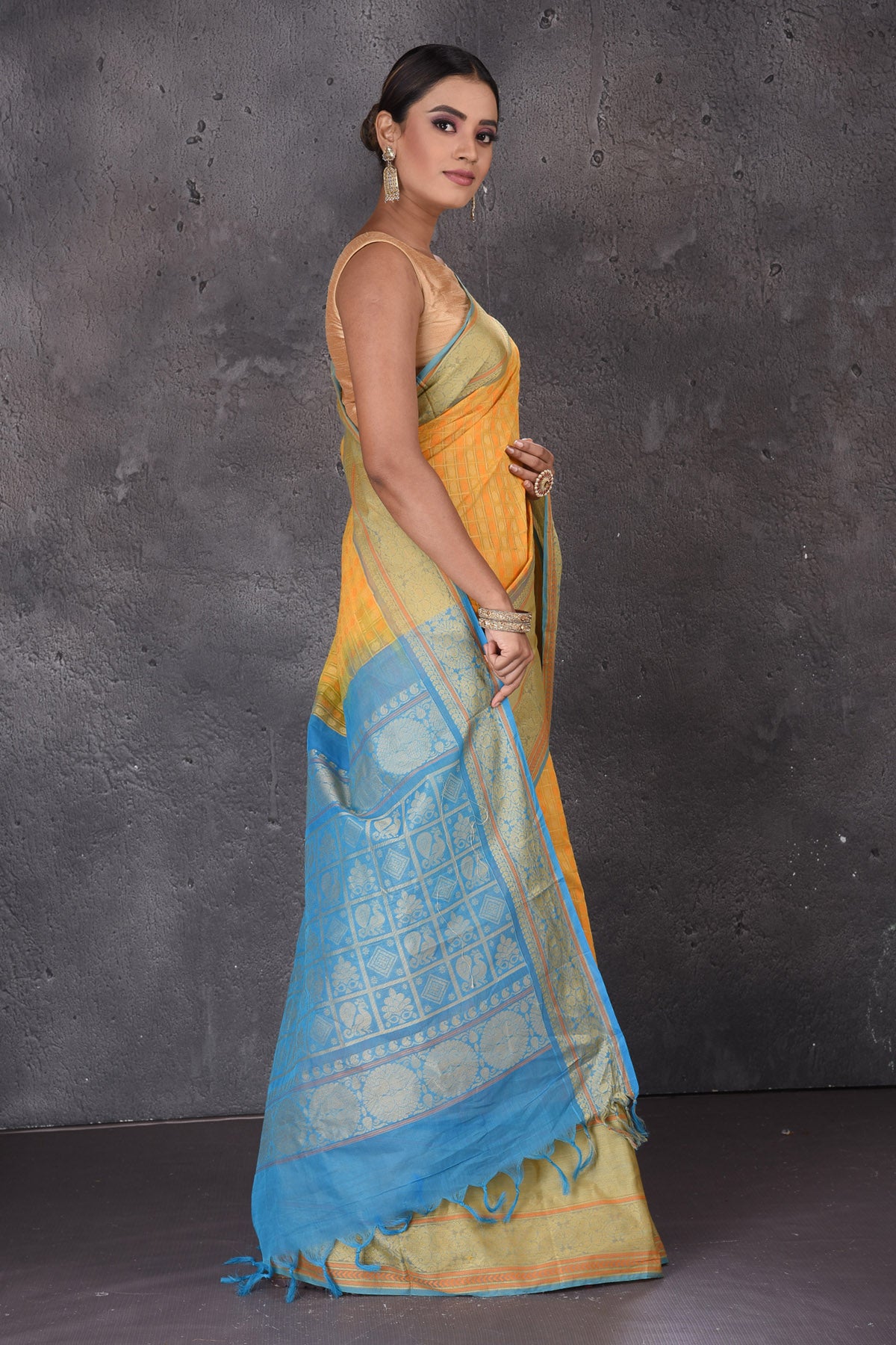 Buy beautiful yellow Kanchipuram cotton saree online in USA with blue zari border. Flaunt your ethnic style on special occasions with latest designer sarees, pure silk sarees, handwoven sarees, Kanchipuram silk sarees, embroidered sarees, georgette sarees from Pure Elegance Indian saree store in USA.-side