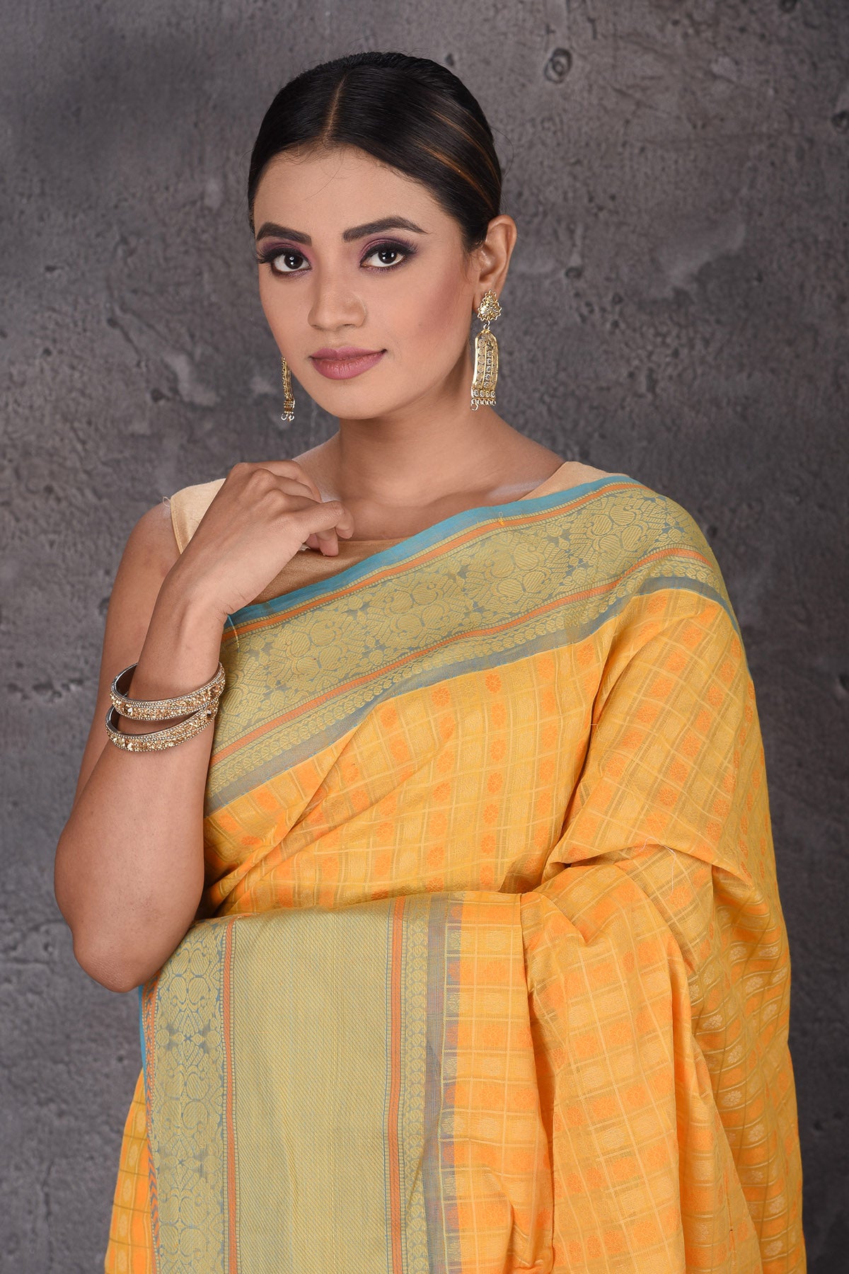 Buy beautiful yellow Kanchipuram cotton saree online in USA with blue zari border. Flaunt your ethnic style on special occasions with latest designer sarees, pure silk sarees, handwoven sarees, Kanchipuram silk sarees, embroidered sarees, georgette sarees from Pure Elegance Indian saree store in USA.-closeup