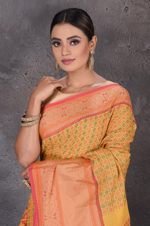 Buy yellow Kanchipuram cotton saree online in USA with pink zari border. Flaunt your ethnic style on special occasions with latest designer sarees, pure silk sarees, handwoven sarees, Kanchipuram silk sarees, embroidered sarees, georgette sarees from Pure Elegance Indian saree store in USA.-closeup