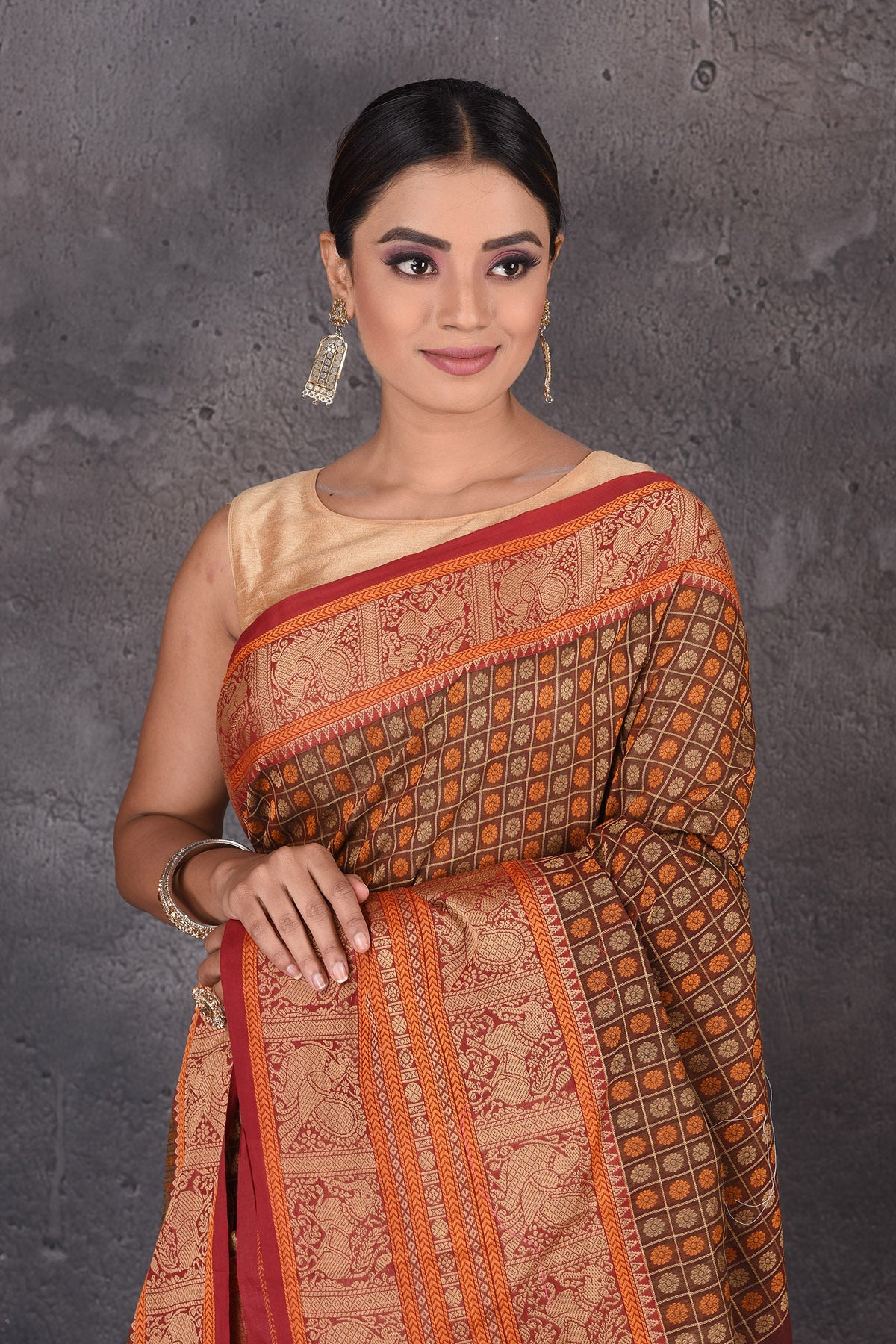 Shop stunning brown Kanchipuram cotton sari online in USA with red orange zari border. Flaunt your ethnic style on special occasions with latest designer sarees, pure silk sarees, handwoven sarees, Kanchipuram silk sarees, embroidered sarees, georgette sarees from Pure Elegance Indian saree store in USA.-closeup
