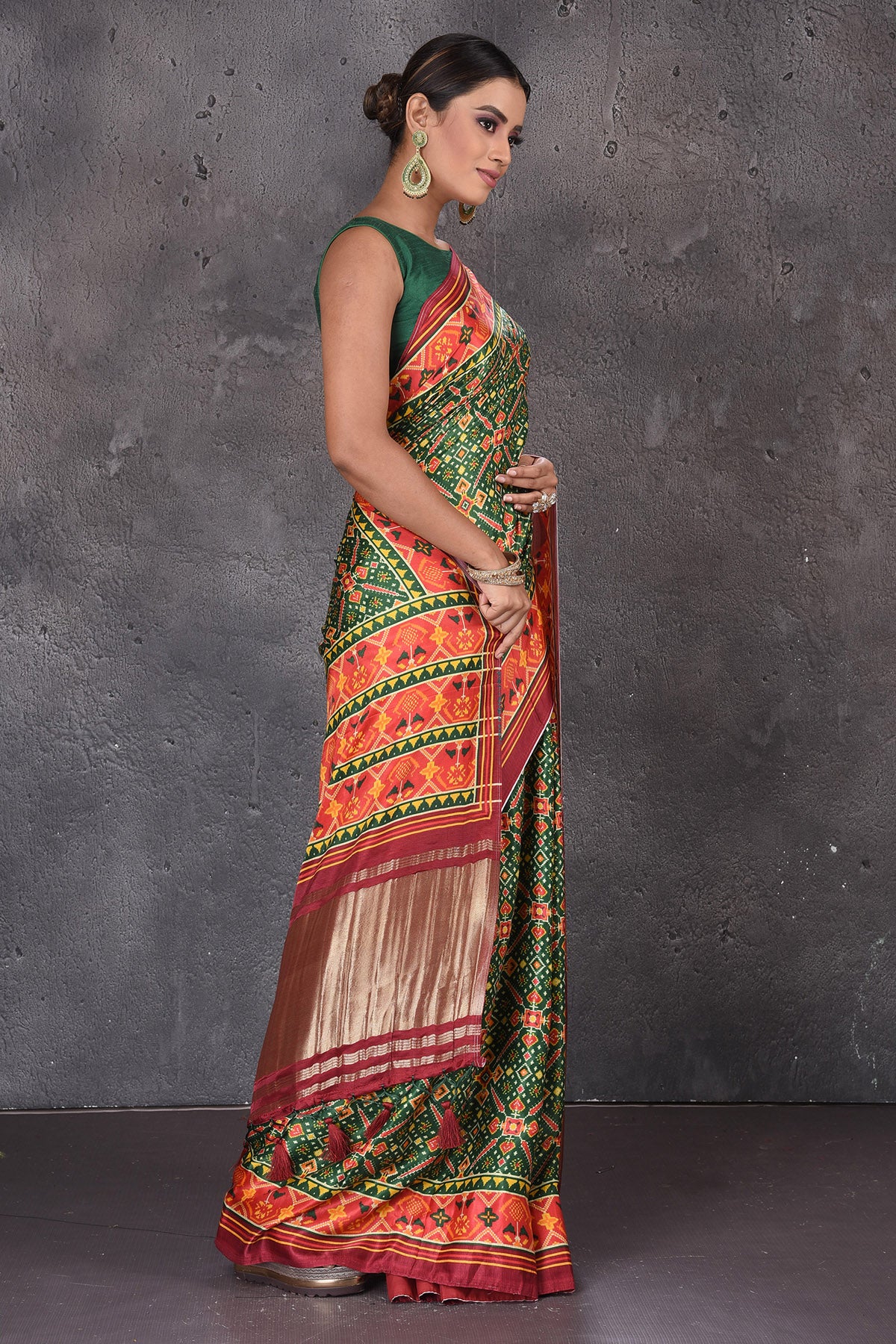 Shop beautiful green Patola print crepe silk saree online in USA with zari pallu. Flaunt your ethnic style on special occasions with latest designer sarees, pure silk sarees, handwoven sarees, Kanchipuram silk sarees, embroidered sarees, georgette sarees, party sarees from Pure Elegance Indian saree store in USA.-side