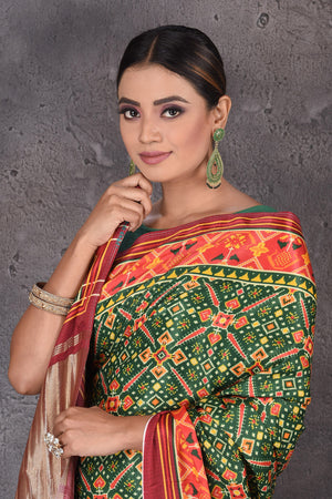 Shop beautiful green Patola print crepe silk saree online in USA with zari pallu. Flaunt your ethnic style on special occasions with latest designer sarees, pure silk sarees, handwoven sarees, Kanchipuram silk sarees, embroidered sarees, georgette sarees, party sarees from Pure Elegance Indian saree store in USA.-closeup