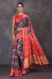 Shop beautiful blue Patola print crepe silk saree online in USA with red border. Flaunt your ethnic style on special occasions with latest designer sarees, pure silk sarees, handwoven sarees, Kanchipuram silk sarees, embroidered sarees, georgette sarees, party sarees from Pure Elegance Indian saree store in USA.-full view