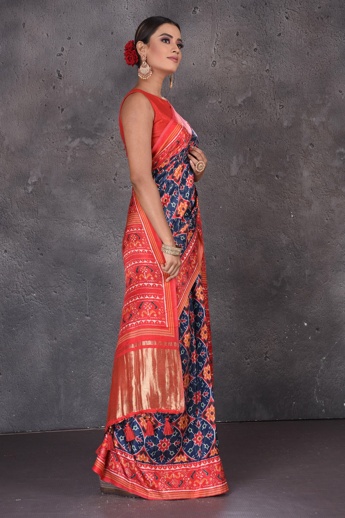 Shop beautiful blue Patola print crepe silk saree online in USA with red border. Flaunt your ethnic style on special occasions with latest designer sarees, pure silk sarees, handwoven sarees, Kanchipuram silk sarees, embroidered sarees, georgette sarees, party sarees from Pure Elegance Indian saree store in USA.-side