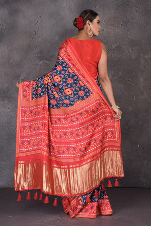 Shop beautiful blue Patola print crepe silk saree online in USA with red border. Flaunt your ethnic style on special occasions with latest designer sarees, pure silk sarees, handwoven sarees, Kanchipuram silk sarees, embroidered sarees, georgette sarees, party sarees from Pure Elegance Indian saree store in USA.-back