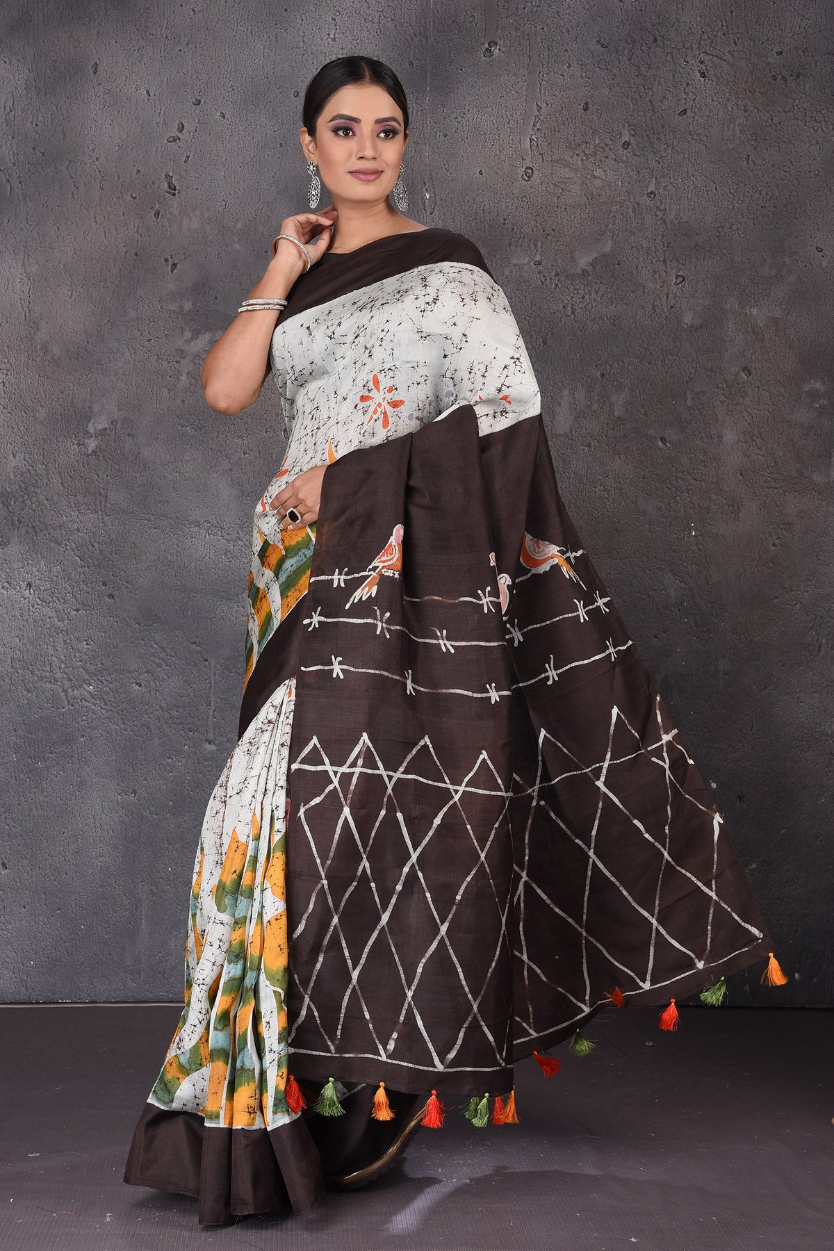 Buy beautiful light grey Batik print silk sari online in USA with brown border and pallu. Flaunt your ethnic style on special occasions with latest designer sarees, pure silk sarees, handwoven sarees, Kanchipuram silk sarees, embroidered sarees, georgette sarees, party sarees from Pure Elegance Indian saree store in USA.-full view
