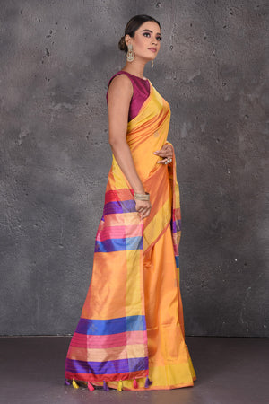 Buy beautiful yellow Bishnupur silk sari online in USA with pink and purple stripes pallu. Flaunt your ethnic style on special occasions with latest designer sarees, pure silk sarees, handwoven sarees, Kanchipuram silk sarees, embroidered sarees, georgette sarees, party sarees from Pure Elegance Indian saree store in USA.-side