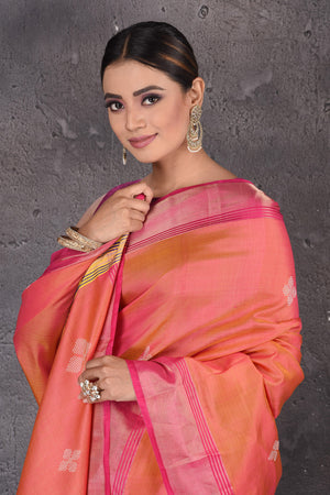 Shop beautiful orange Bishnupur silk saree online in USA with pink zari border. Flaunt your ethnic style on special occasions with latest designer sarees, pure silk sarees, handwoven sarees, Kanchipuram silk sarees, embroidered sarees, georgette sarees, party sarees from Pure Elegance Indian saree store in USA.-closeup