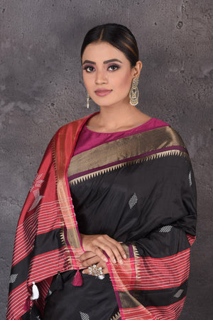 Buy beautiful black Bishnupur silk sari online in USA with red zari pallu. Flaunt your ethnic style on special occasions with latest designer sarees, pure silk sarees, handwoven sarees, Kanchipuram silk sarees, embroidered sarees, georgette sarees, party sarees from Pure Elegance Indian saree store in USA.-closeup