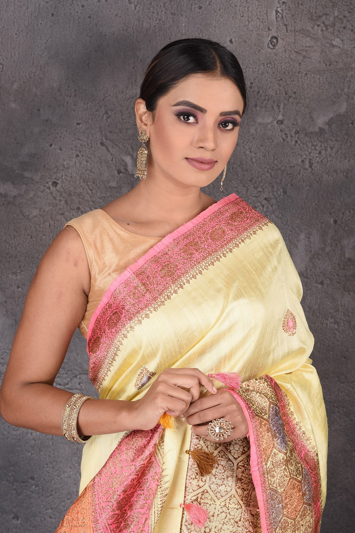 Buy stunning light yellow dupion silk saree online in USA with antique zari border. Flaunt your ethnic style on special occasions with latest designer sarees, pure silk sarees, handwoven sarees, Kanchipuram silk sarees, embroidered sarees, georgette sarees, party sarees from Pure Elegance Indian saree store in USA.-closeup