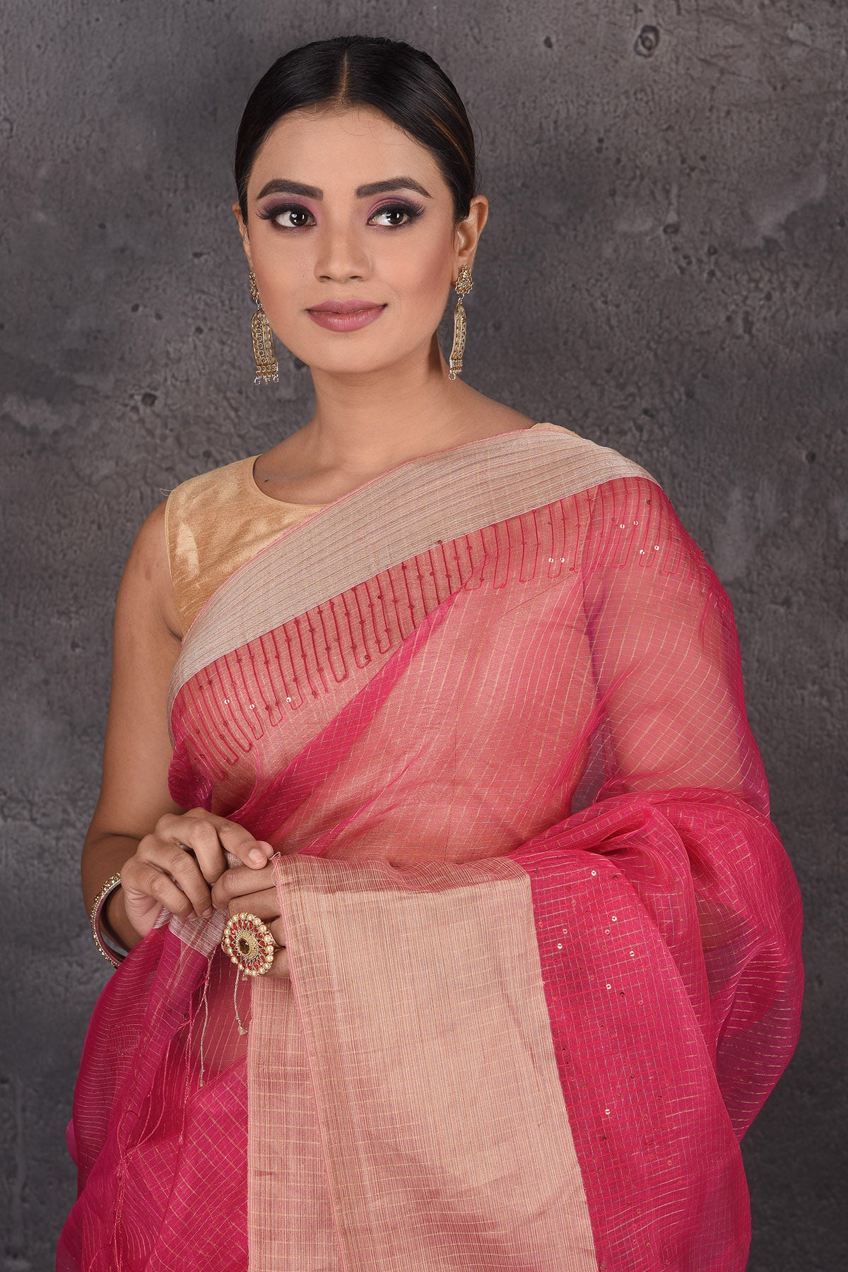 Shop stunning pink organza silk sari online in USA with golden zari border. Flaunt your ethnic style on special occasions with latest designer sarees, pure silk sarees, handwoven sarees, Kanchipuram silk sarees, embroidered sarees, georgette sarees, party sarees from Pure Elegance Indian saree store in USA.-closeup