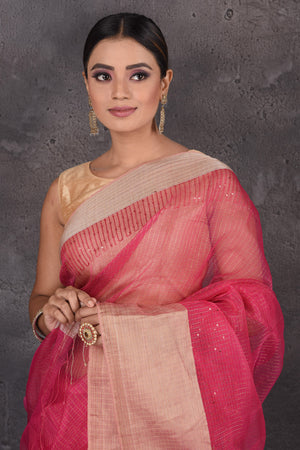 Shop stunning pink organza silk sari online in USA with golden zari border. Flaunt your ethnic style on special occasions with latest designer sarees, pure silk sarees, handwoven sarees, Kanchipuram silk sarees, embroidered sarees, georgette sarees, party sarees from Pure Elegance Indian saree store in USA.-closeup