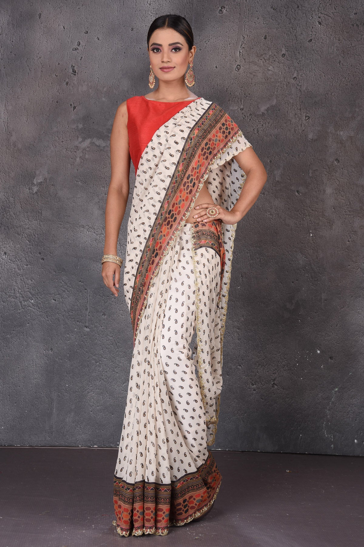 Shop stunning off-white printed georgette sari online in USA with embroidered border. Flaunt your ethnic style on special occasions with latest designer sarees, pure silk sarees, handwoven sarees, Kanchipuram silk sarees, embroidered sarees, georgette sarees, party sarees from Pure Elegance Indian saree store in USA.-full view