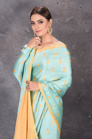 Shop stunning pastel green modal silk saree online in USA with printed buta. Keep your ethnic wardrobe up to date with latest designer sarees, pure silk sarees, handwoven sarees, tussar silk sarees, embroidered sarees from Pure Elegance Indian saree store in USA.-closeup