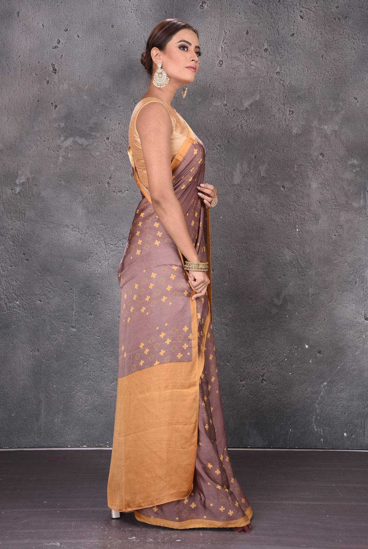 Buy elegant brown modal silk saree online in USA with printed overall buta. Keep your ethnic wardrobe up to date with latest designer sarees, pure silk sarees, handwoven sarees, tussar silk sarees, embroidered sarees from Pure Elegance Indian saree store in USA.-side