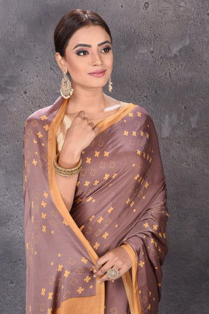 Buy elegant brown modal silk saree online in USA with printed overall buta. Keep your ethnic wardrobe up to date with latest designer sarees, pure silk sarees, handwoven sarees, tussar silk sarees, embroidered sarees from Pure Elegance Indian saree store in USA.-closeup