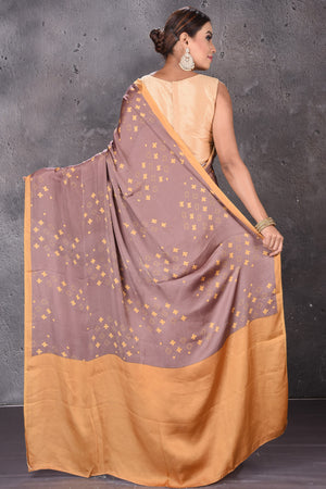Buy elegant brown modal silk saree online in USA with printed overall buta. Keep your ethnic wardrobe up to date with latest designer sarees, pure silk sarees, handwoven sarees, tussar silk sarees, embroidered sarees from Pure Elegance Indian saree store in USA.-back