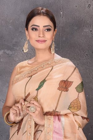 Buy beautiful beige printed Kota silk saree online in USA with embroidered zari border. Keep your ethnic wardrobe up to date with latest designer sarees, pure silk sarees, handwoven sarees, tussar silk sarees, embroidered sarees from Pure Elegance Indian saree store in USA.-closeup