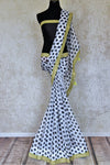 Buy beautiful white and black polka dot organza sari online in USA with embroidered border. Look beautiful on special occasions in this beautiful designer sarees, printed sarees, embroidered sarees, fancy sarees, partywear sarees from Pure Elegance Indian saree store in USA.-full view