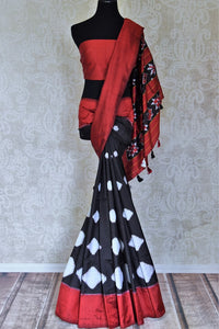 Shop gorgeous black Pochampally ikkat sari online in USA with red border. Flaunt your sartorial choices on special occasions in stunning designer sarees, embroidered sarees, handloom sarees, Banarasi sarees, crepe sarees from Pure Elegance Indian fashion store in USA.-full view