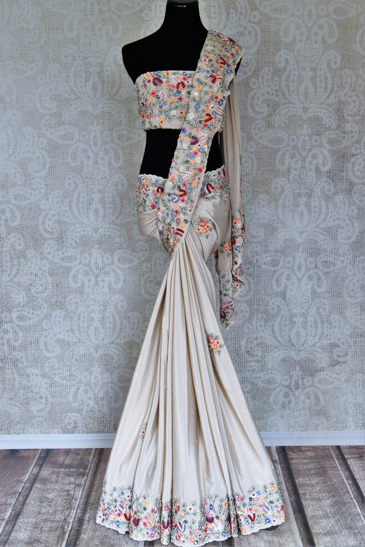 Buy beautiful beige floral crepe silk sari online in USA with hand embroidered border. Flaunt your sartorial choices on special occasions in stunning designer sarees, embroidered sarees, handloom sarees, Banarasi sarees, crepe sarees from Pure Elegance Indian fashion store in USA.-full view