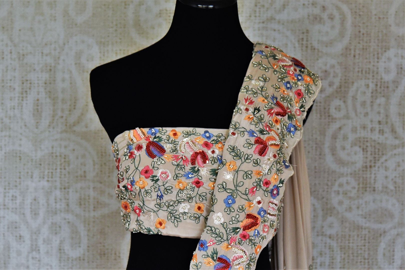 Buy beautiful beige floral crepe silk sari online in USA with hand embroidered border. Flaunt your sartorial choices on special occasions in stunning designer sarees, embroidered sarees, handloom sarees, Banarasi sarees, crepe sarees from Pure Elegance Indian fashion store in USA.-blouse pallu