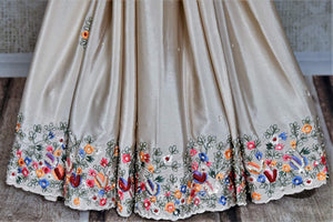 Buy beautiful beige floral crepe silk sari online in USA with hand embroidered border. Flaunt your sartorial choices on special occasions in stunning designer sarees, embroidered sarees, handloom sarees, Banarasi sarees, crepe sarees from Pure Elegance Indian fashion store in USA.-pleats